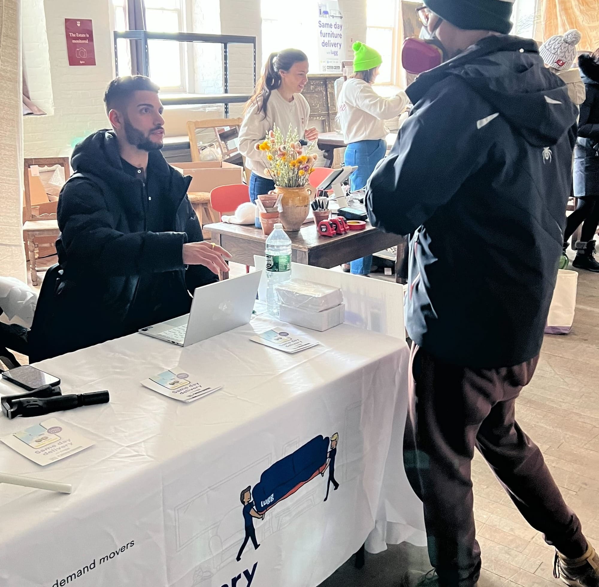 Lugg team member helping customer at delivery coordination booth during Sylvie Estate Sale