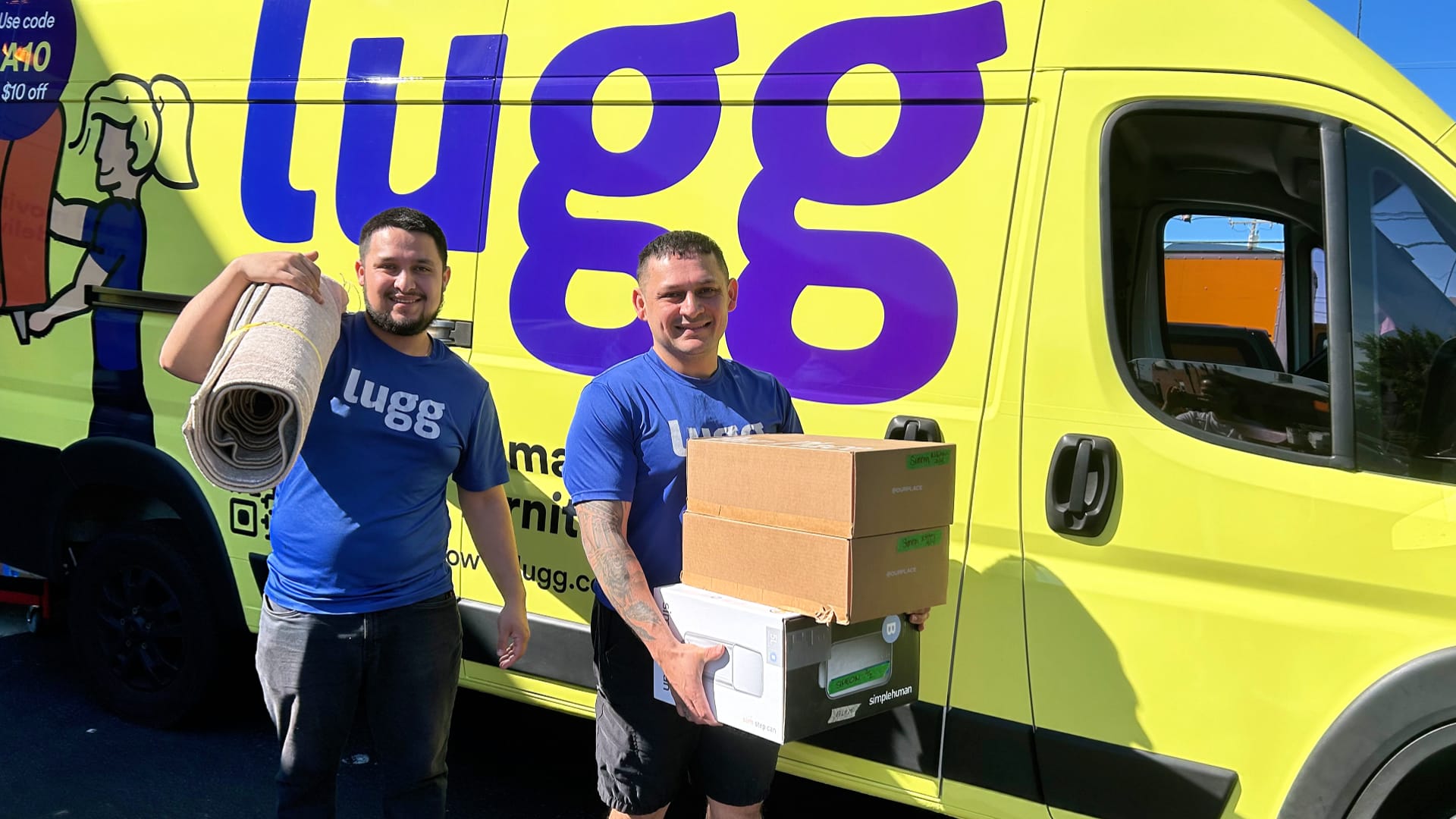 Two Lugg movers posing with a branded yellow Lugg van featuring the vehicle advertising wrap