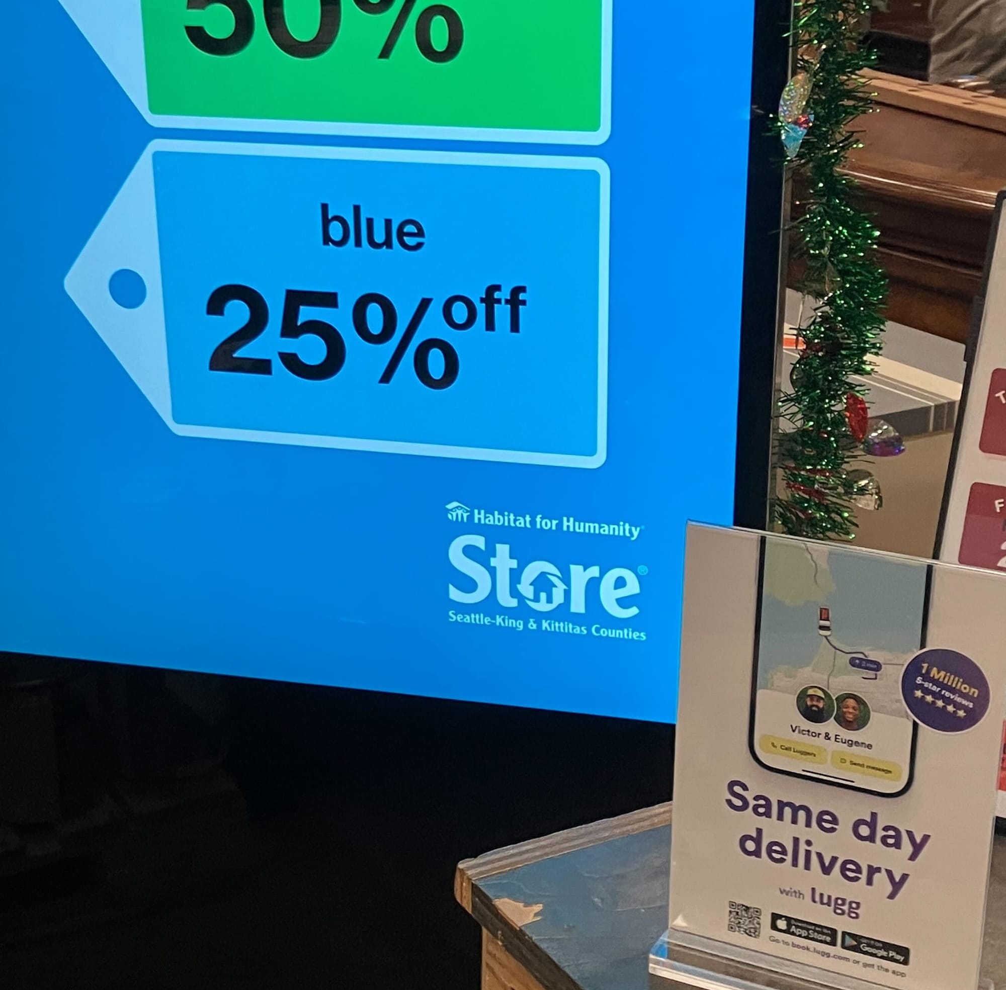 Lugg same-day delivery flyers displayed at a Habitat for Humanity ReStore checkout counter