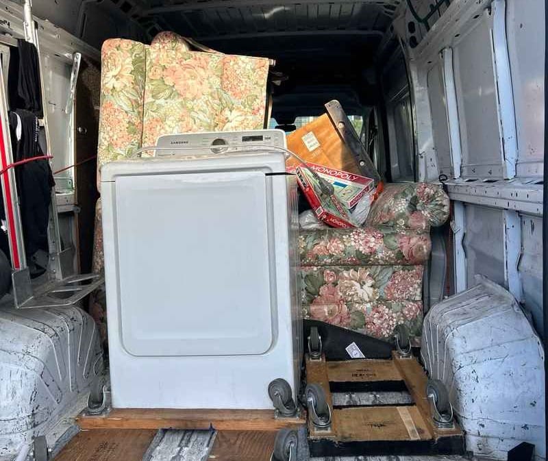 Appliances and old furniture loaded inside a moving van by Lugg movers for donation and junk removal