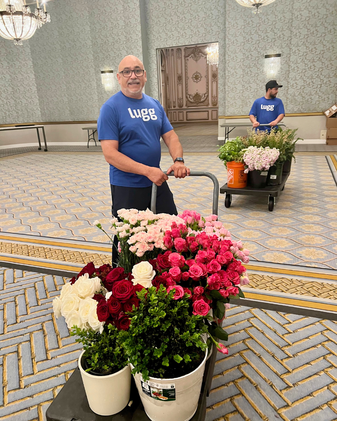 Two Lugg movers deliver fresh flowers with dollies for on-demand Valentine’s Day gift and event set updelivery.