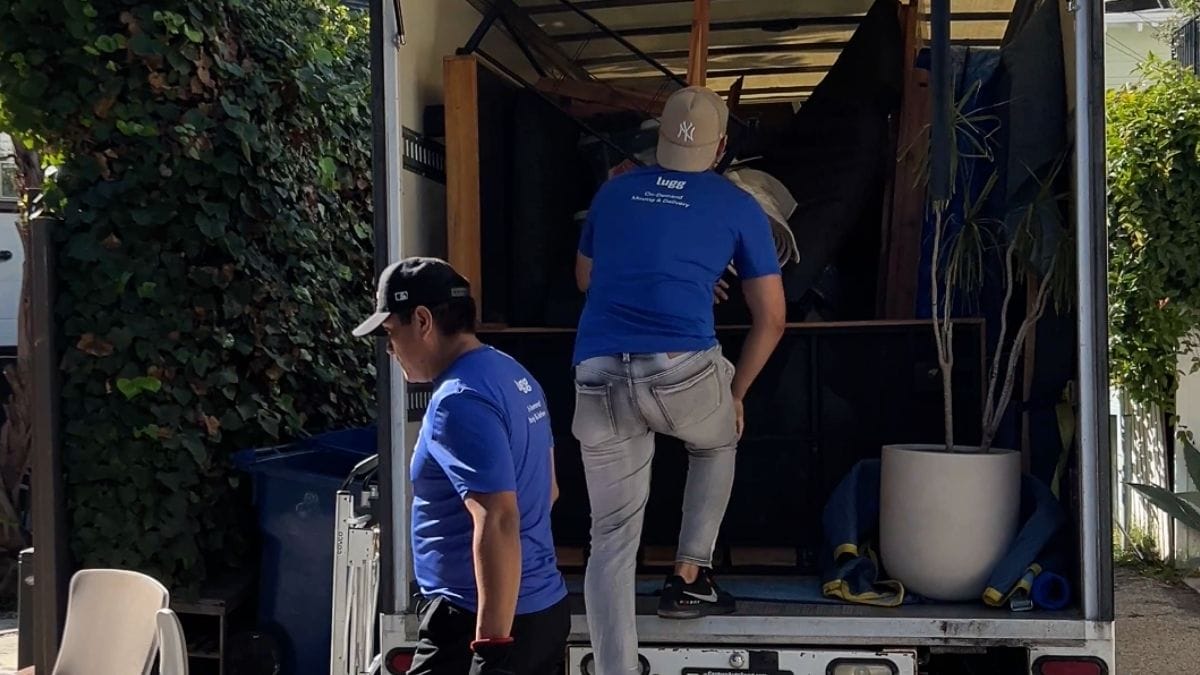 Lugg movers loading large items into a box truck, showing the largest Lugg vehicle option.